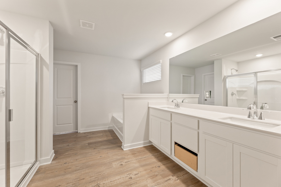 A bathroom with white cabinets.