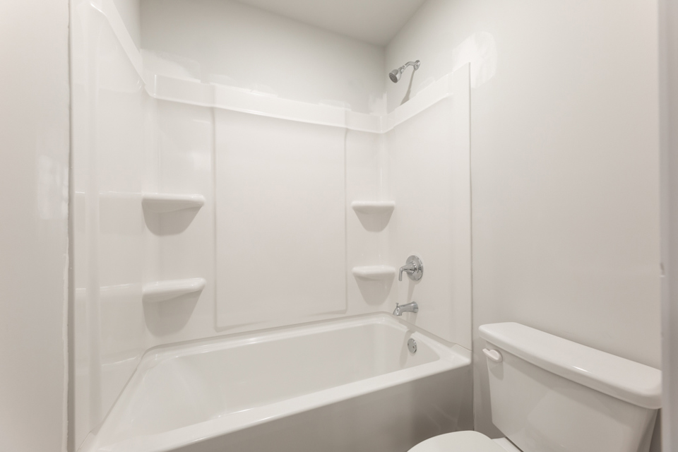 A bathroom with a bathtub toilet and sink.