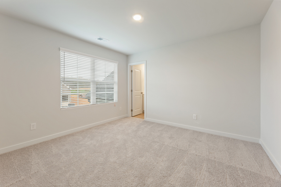 A room with a window and a door.