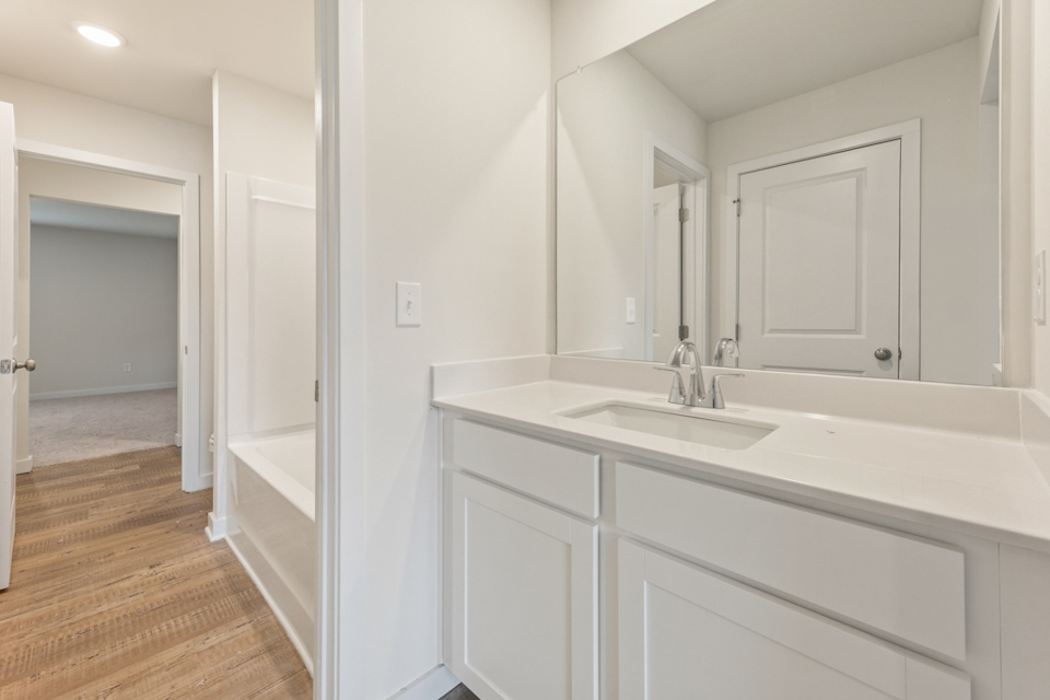 A bathroom with a tub sink and a shower.