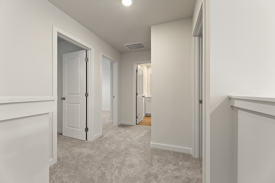 A hallway with white walls.