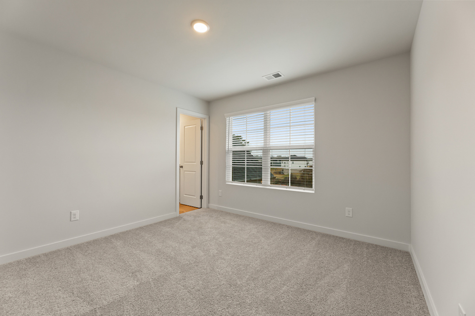 A room with a window and a door.