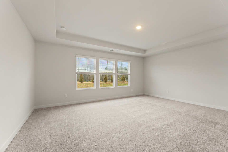 A room with a window and a carpet.