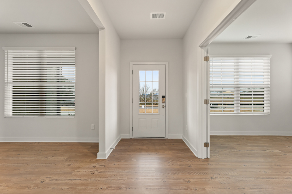 A room with a wood floor and white walls.