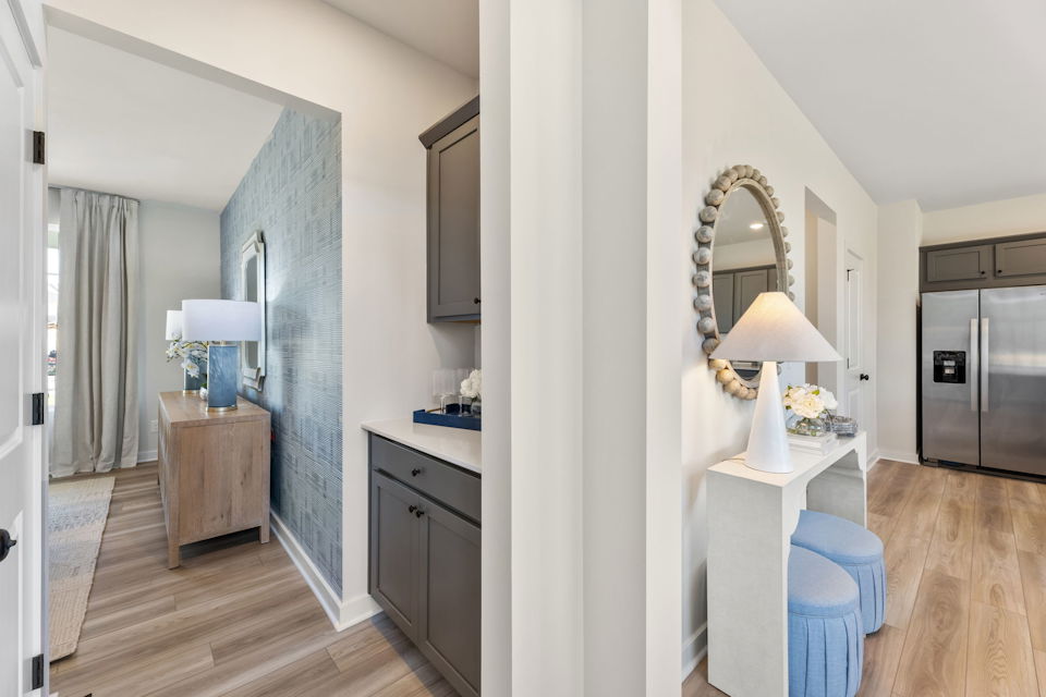 A room with a mirror and a table.