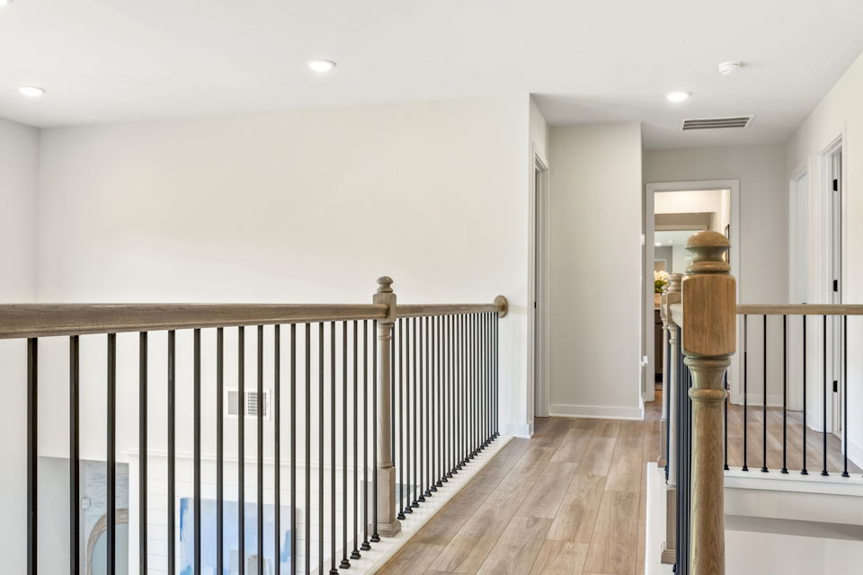A room with a railing and a wood railing.