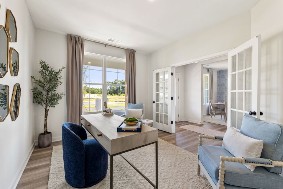 A living room with a table and chairs.