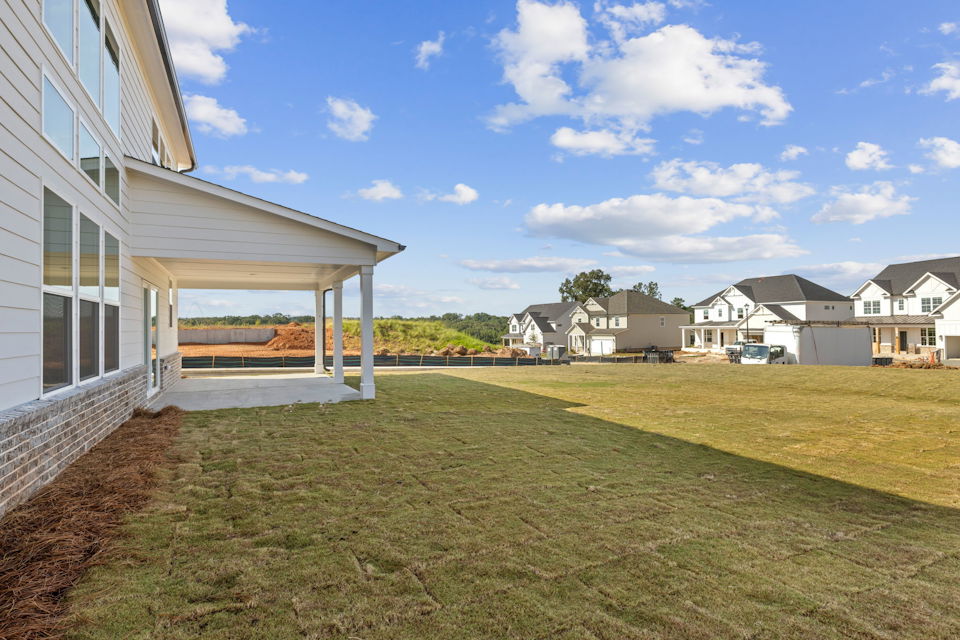 A grassy area with buildings in the background.
