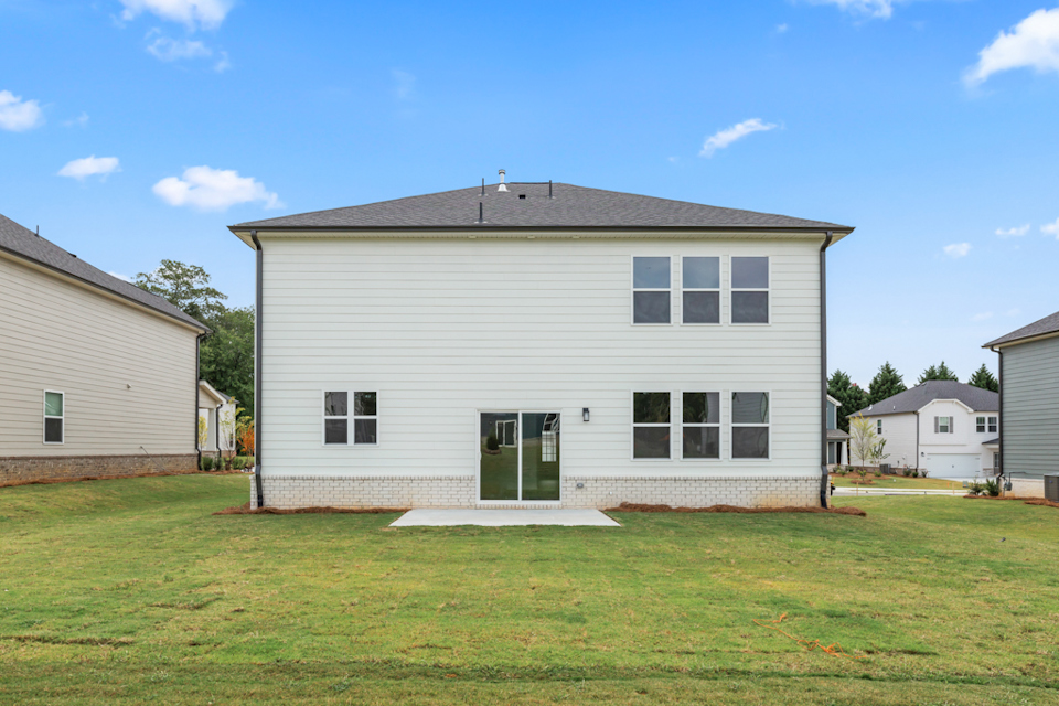 A house with a lawn in front of it.