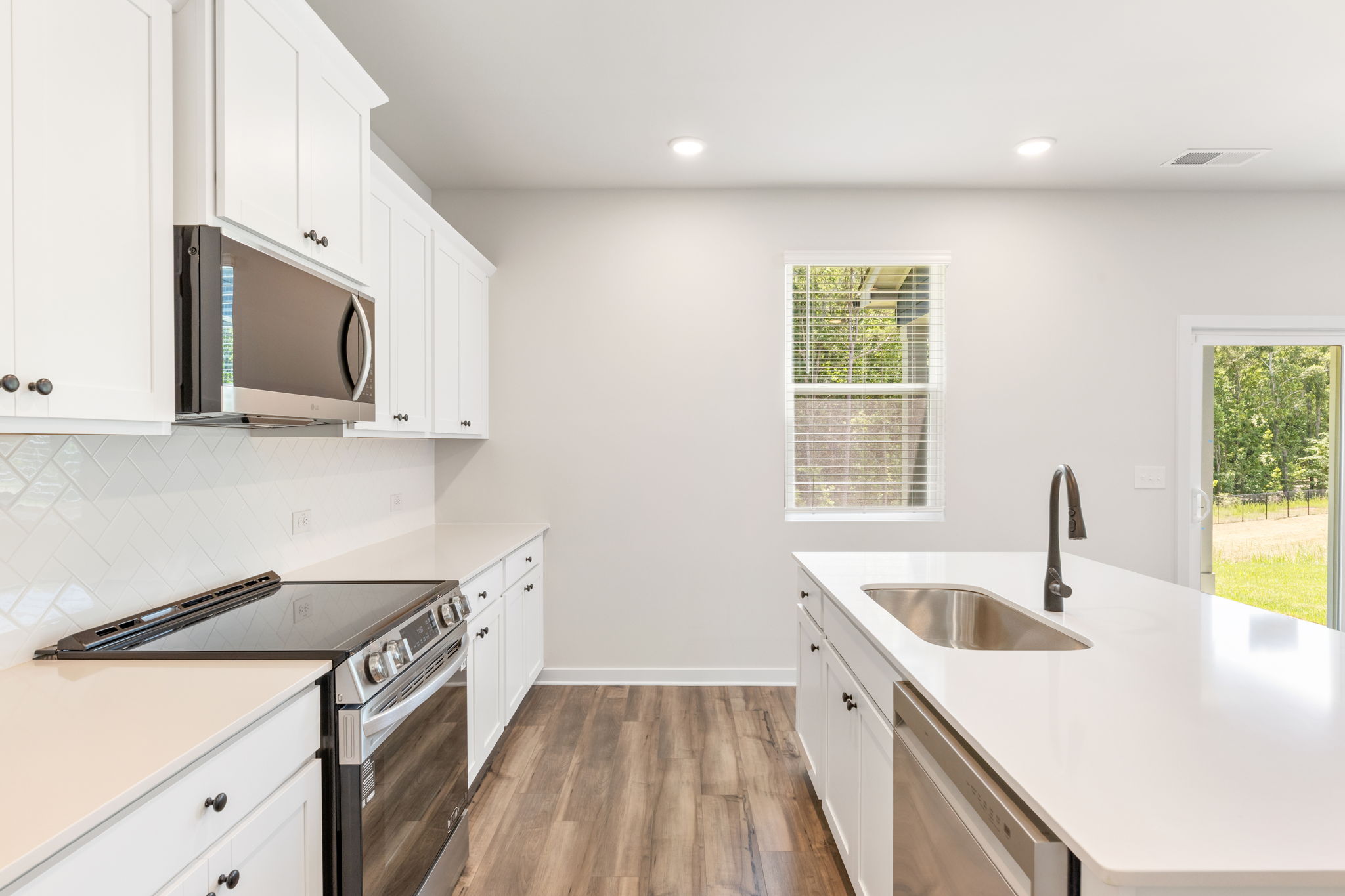 A kitchen with white cabinets.