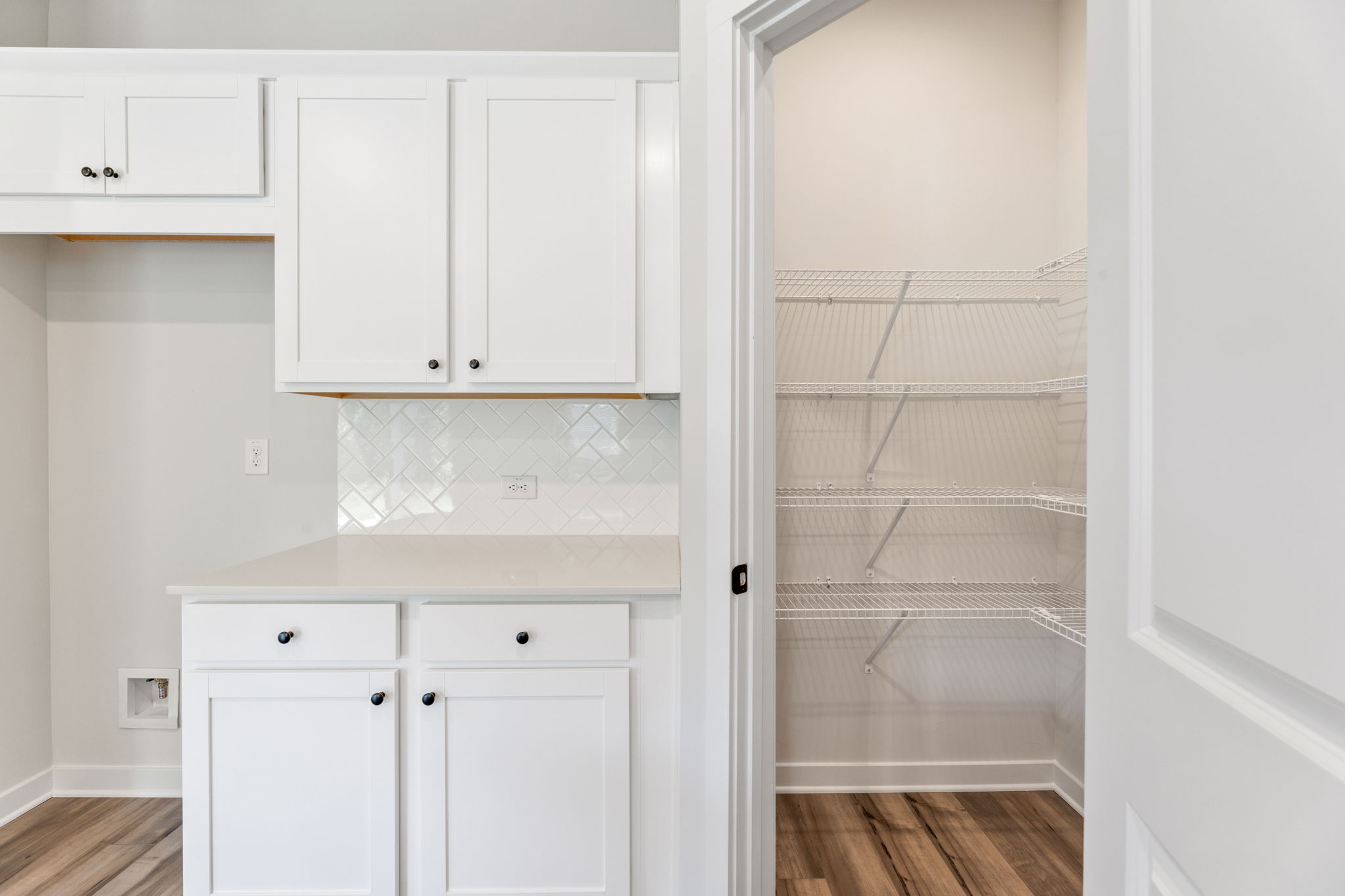 A white kitchen with white cabinets.