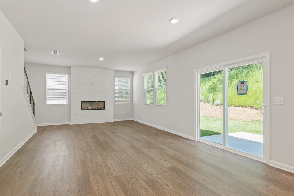 A room with a wood floor and a wood floor with a glass door.