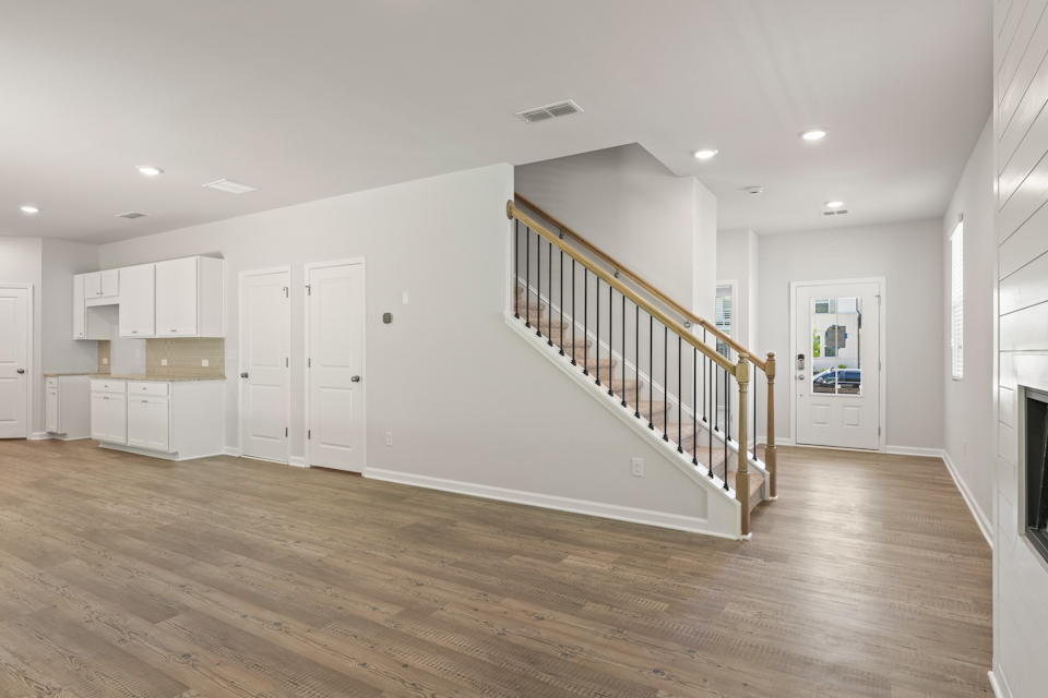 A long hallway with white doors.