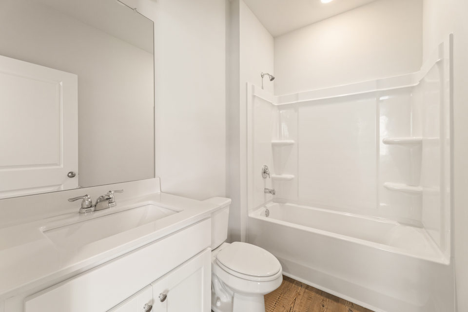 A bathroom with a tub sink and toilet.