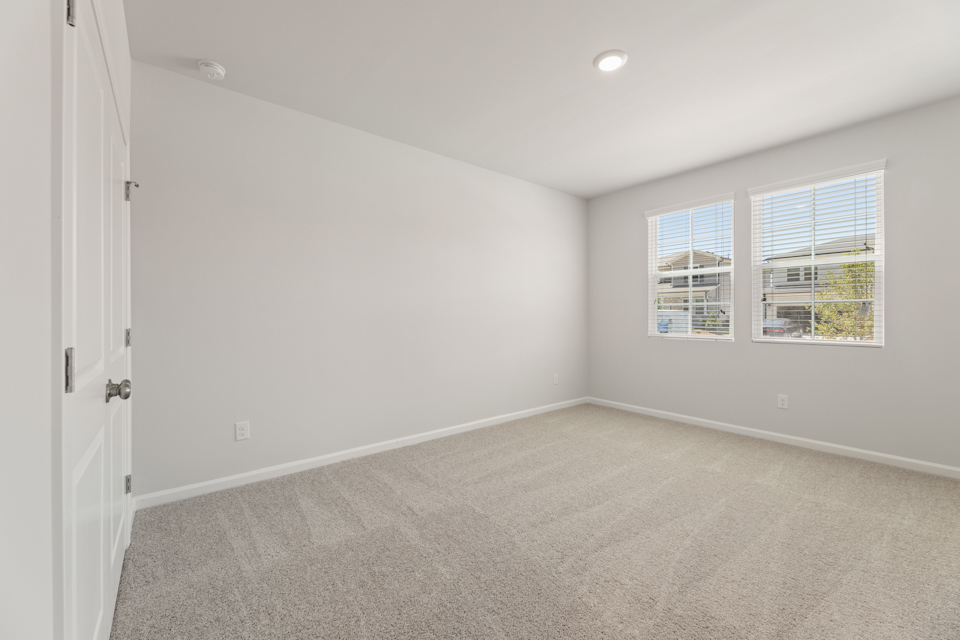 A room with a window and a carpet.