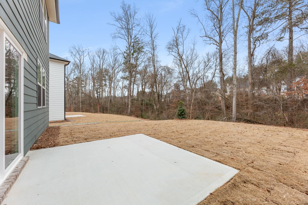 A dirt path next to a house.