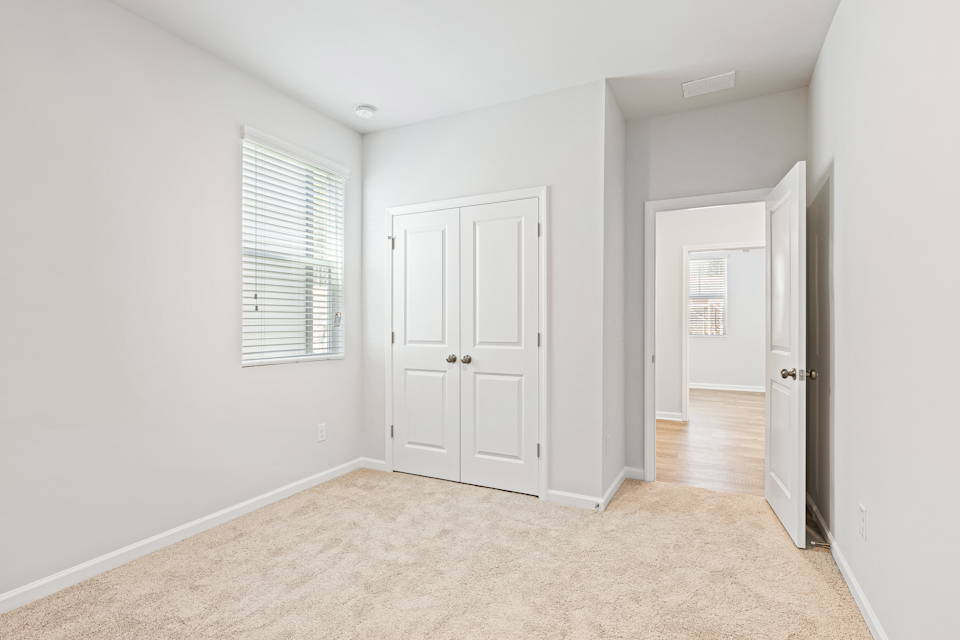 A hallway with white doors.