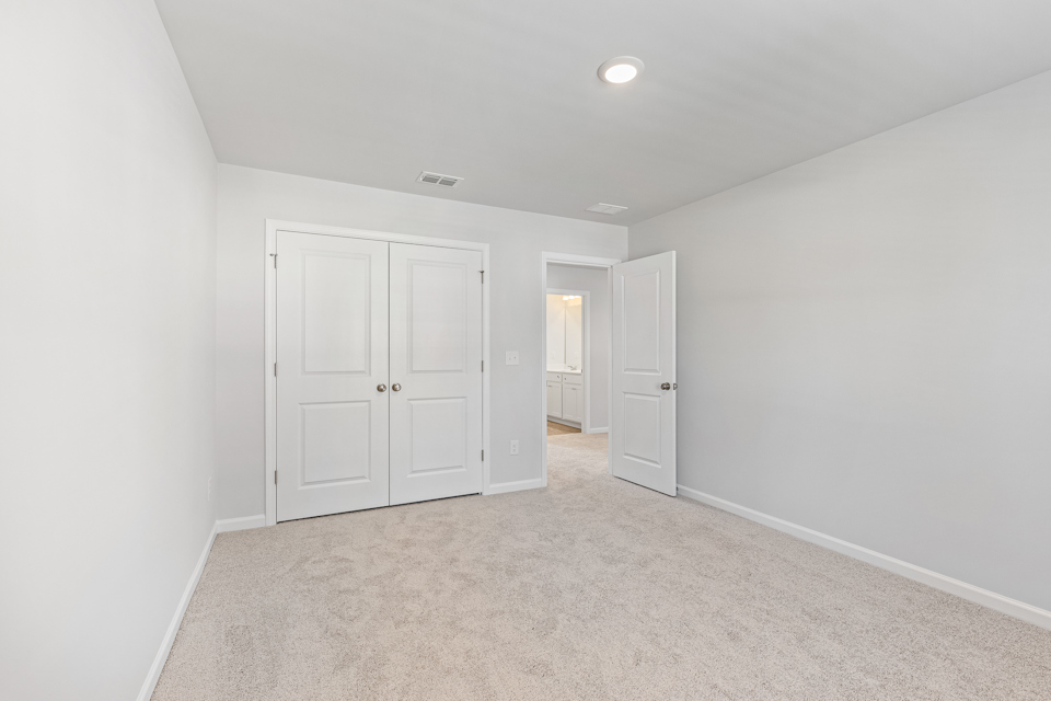 A hallway with white doors.