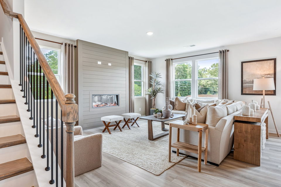 A living room with a staircase.