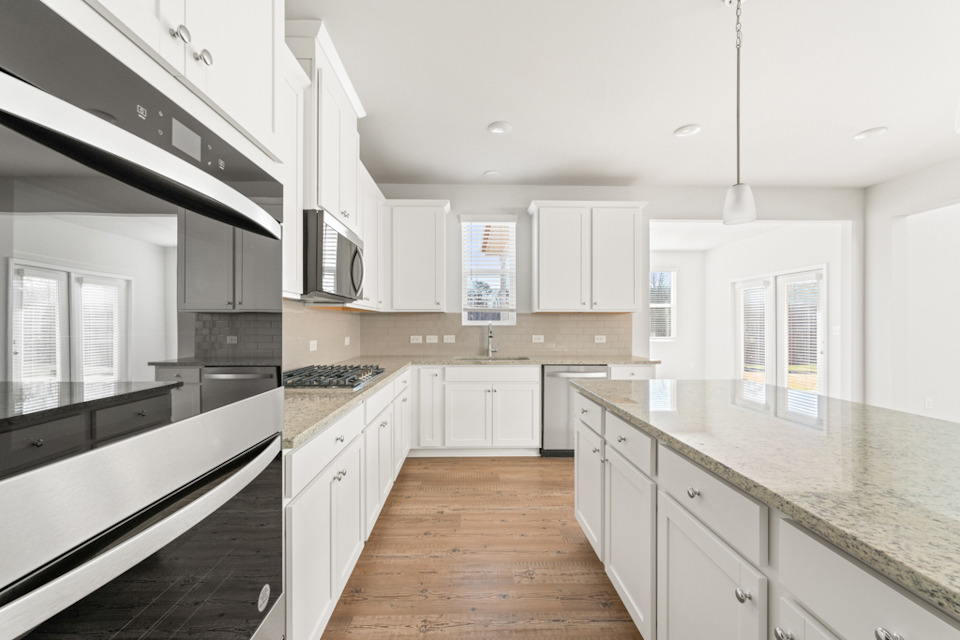 A kitchen with white cabinets.