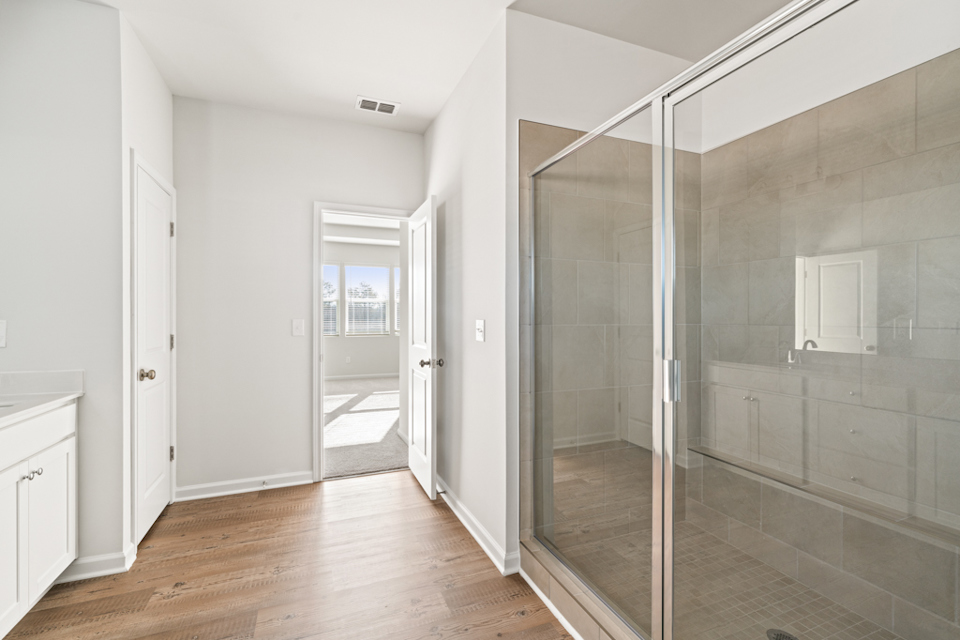 A room with a glass shower.