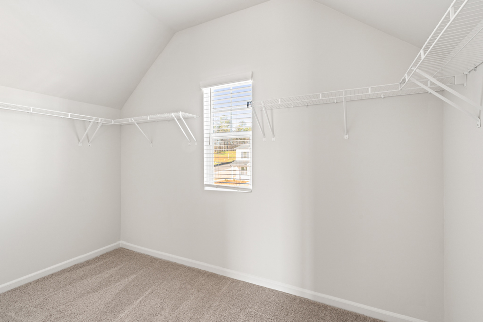 A room with a window and a carpet.