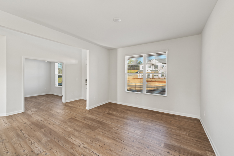 A room with a wood floor and a window.