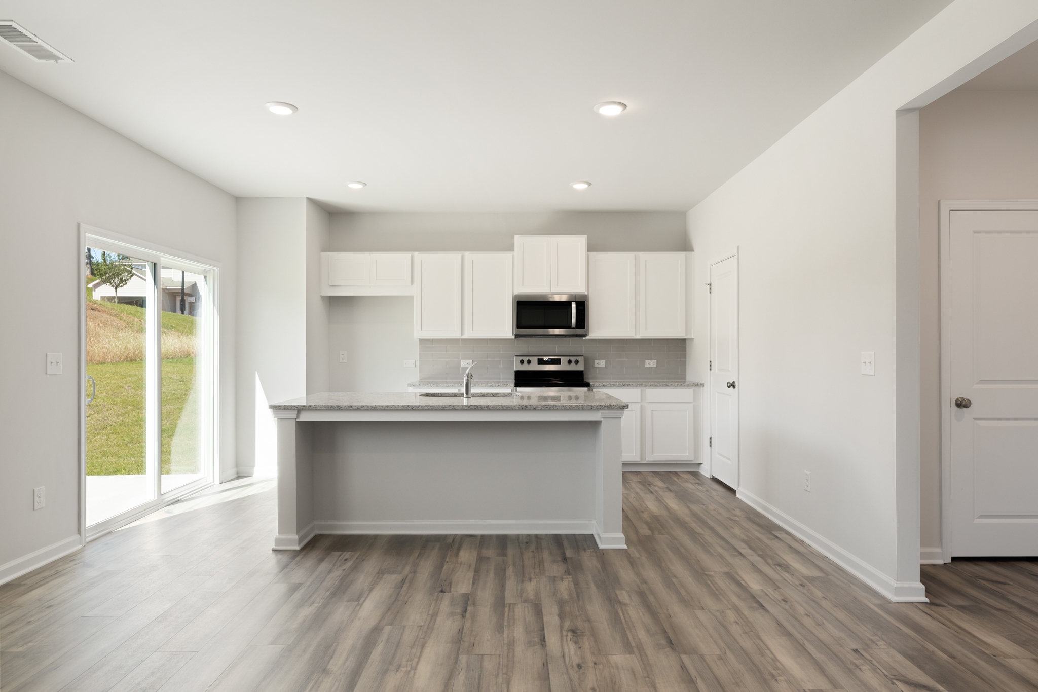 A kitchen with white cabinets.
