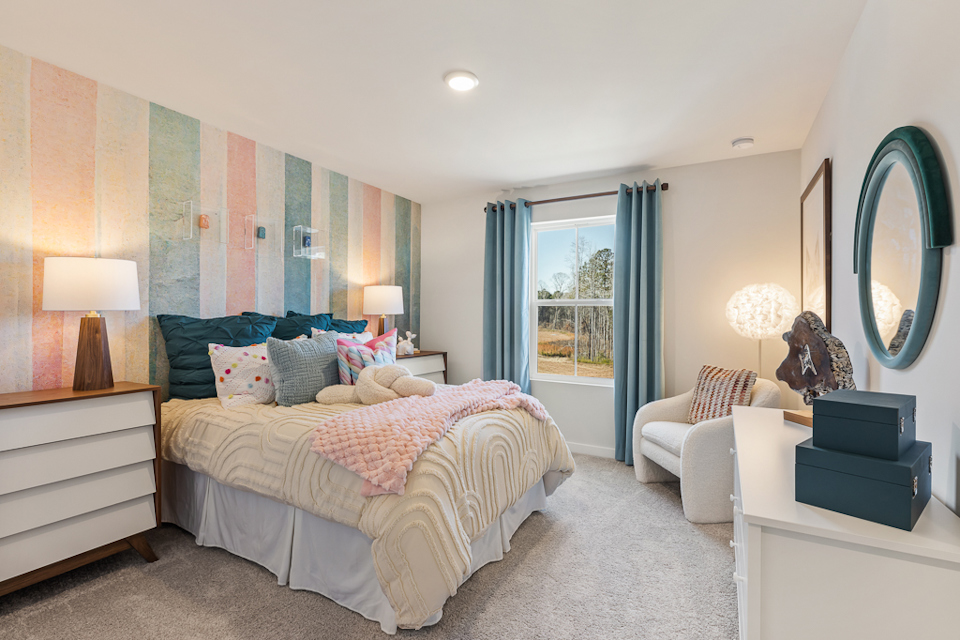 A bedroom with a large mirror.