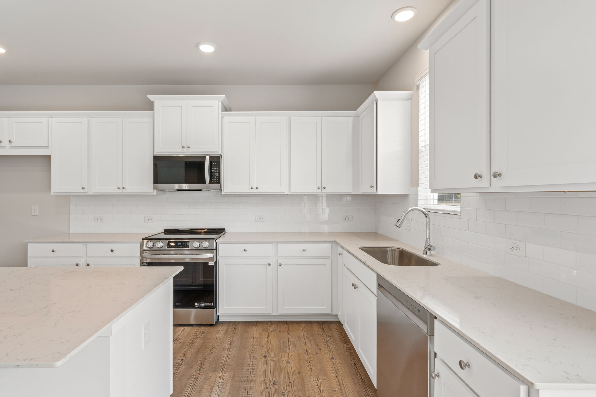 A kitchen with white cabinets.