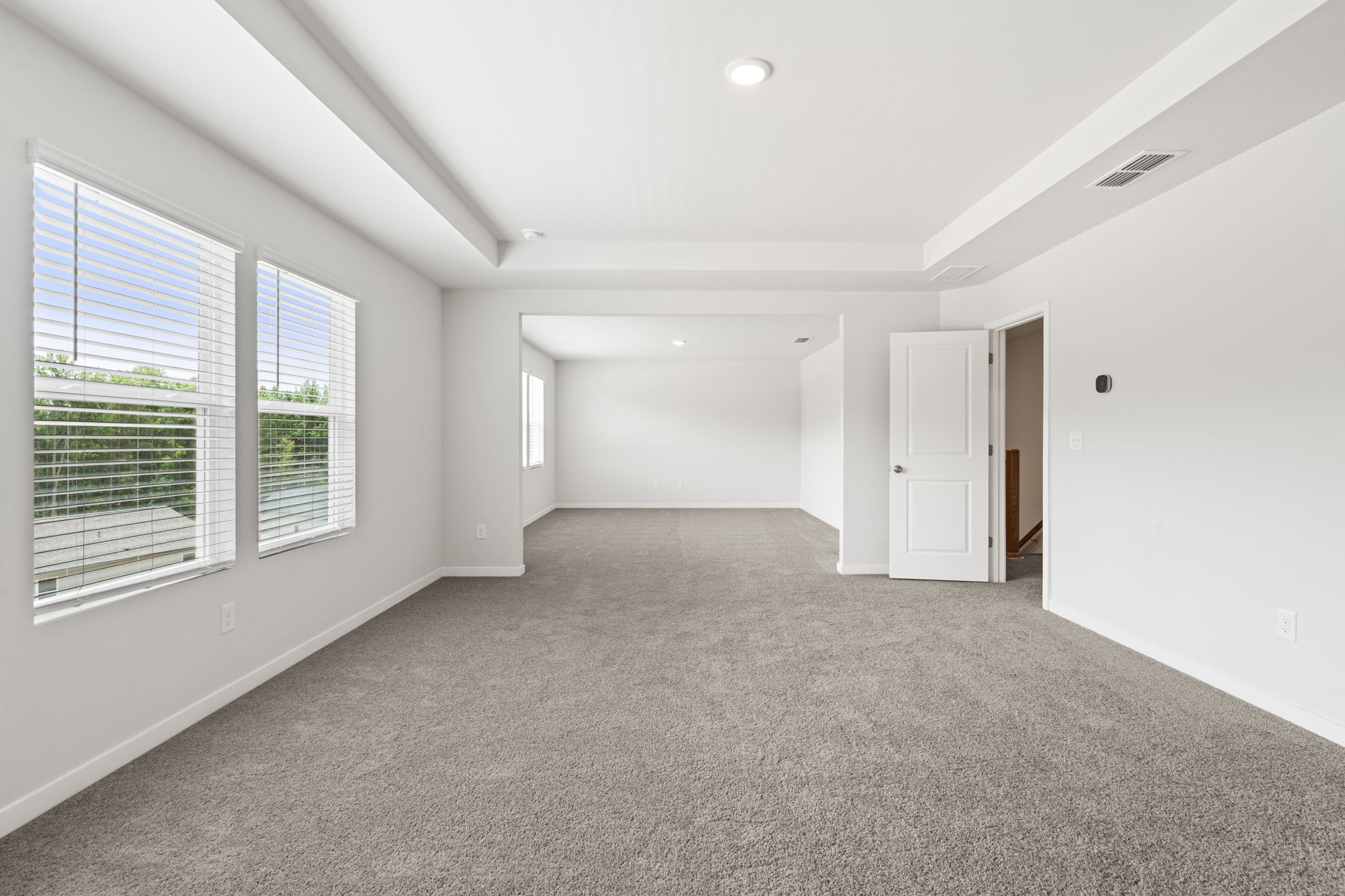 A room with white walls and windows.