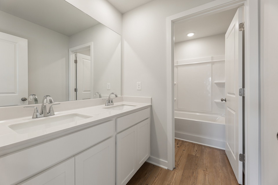 A bathroom with a sink and a shower.