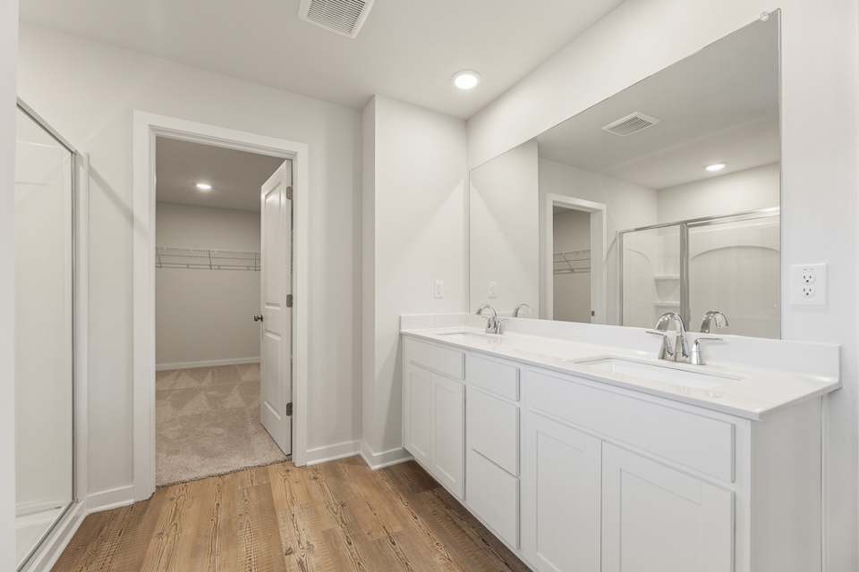 A bathroom with white cabinets.