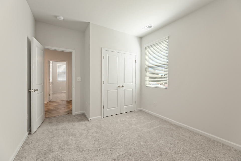 A hallway with white doors.