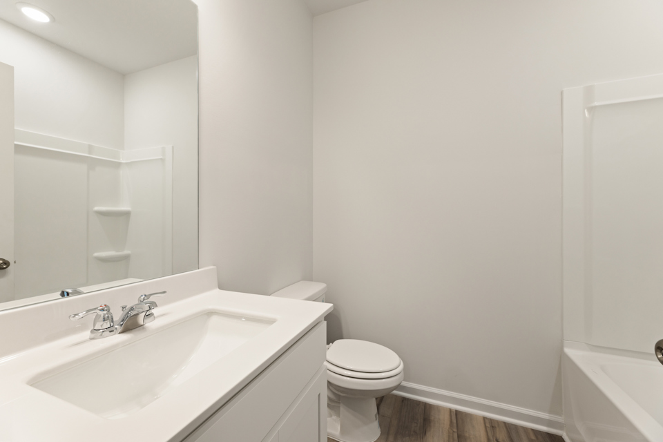 A bathroom with a sink toilet and bathtub.