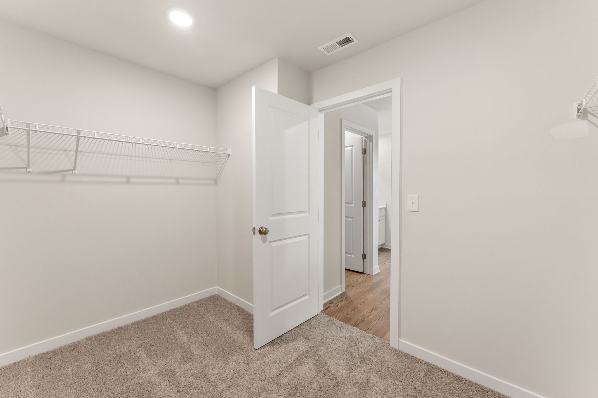 A hallway with white walls.
