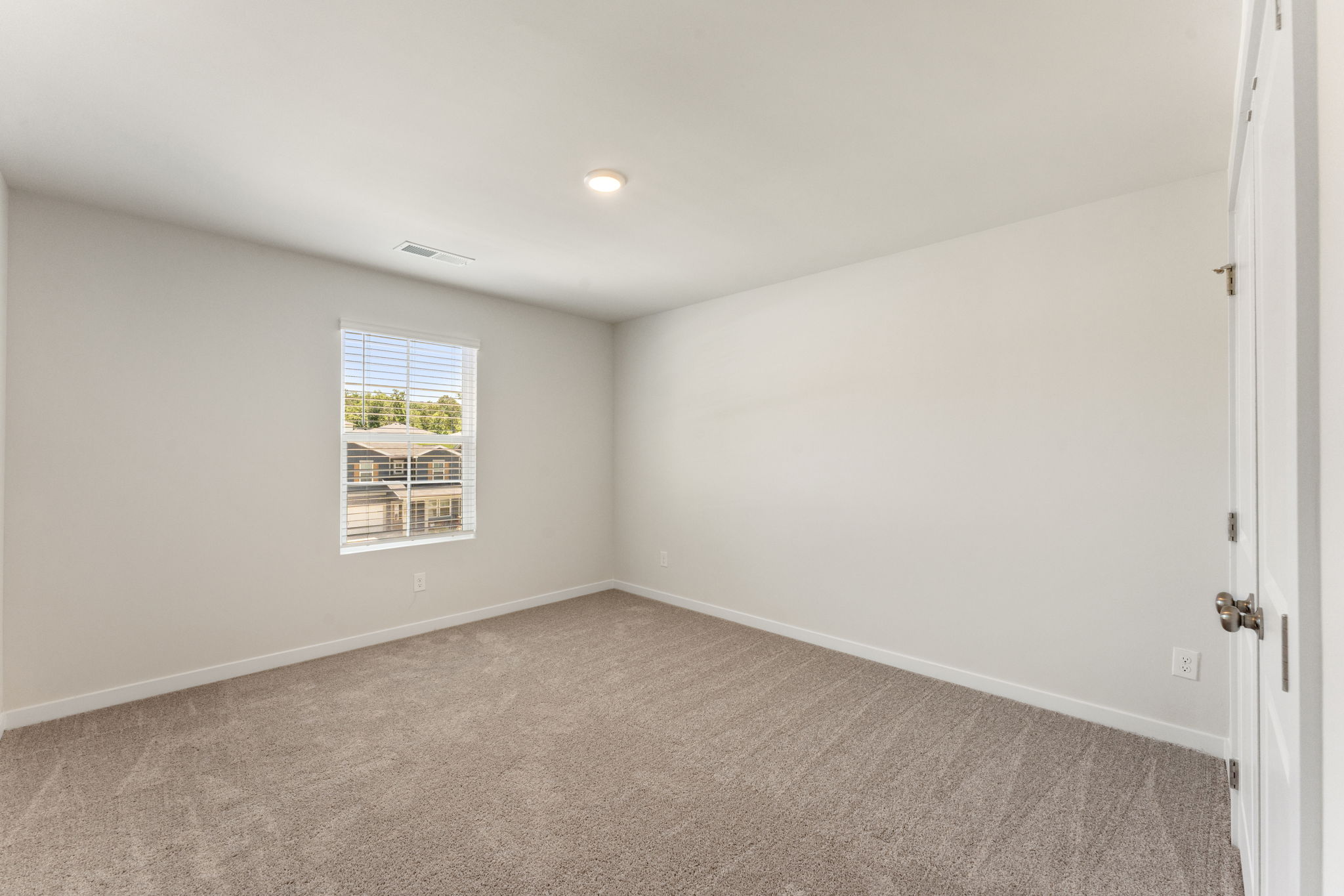 A room with a window and a door.