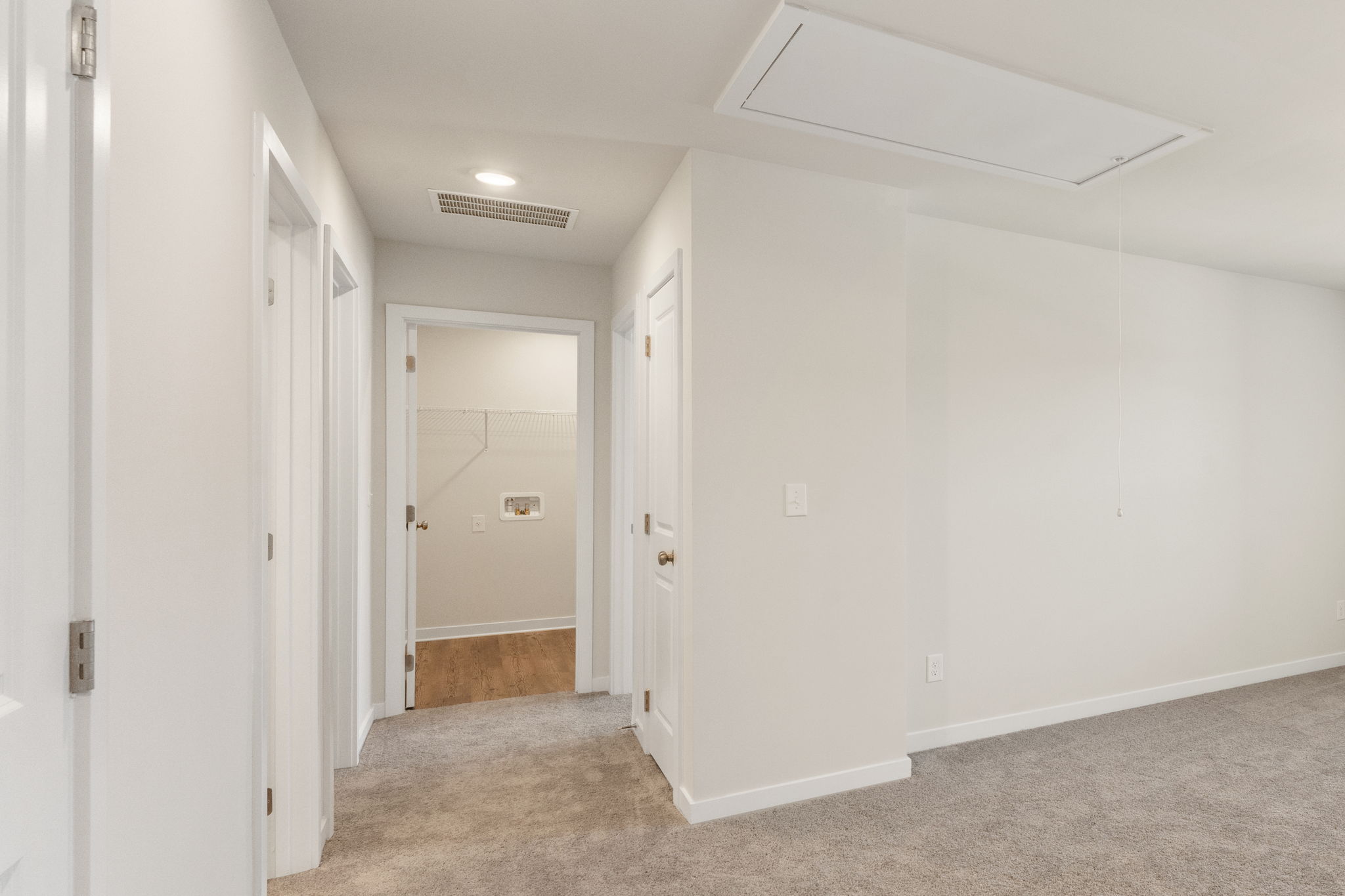 A hallway with white doors.