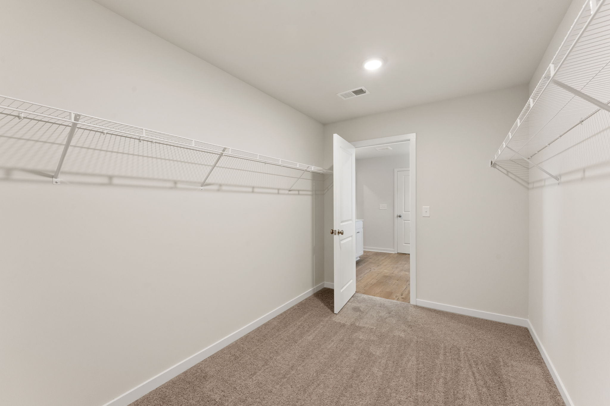 A hallway with white walls.
