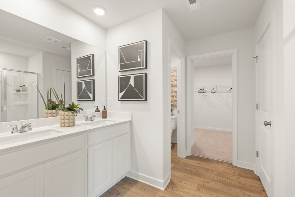 A bathroom with white cabinets.