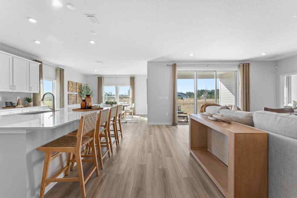 A large kitchen with a dining table.