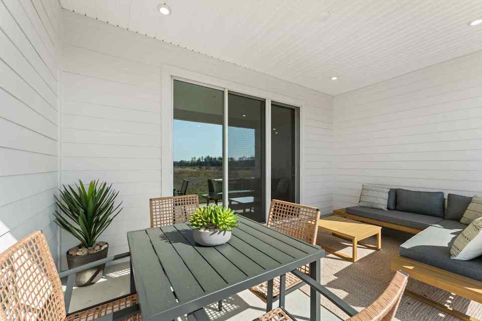 A living room with a table and chairs.