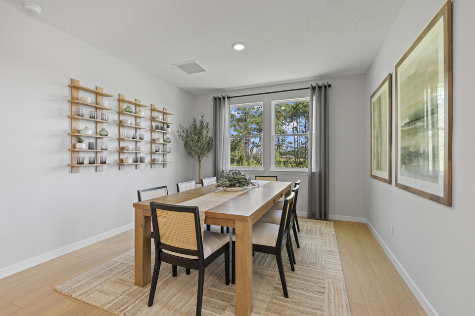 Kenai Model Home Dining Room with Large Table and Eight Chairs at Reserve East in Flagler Beach