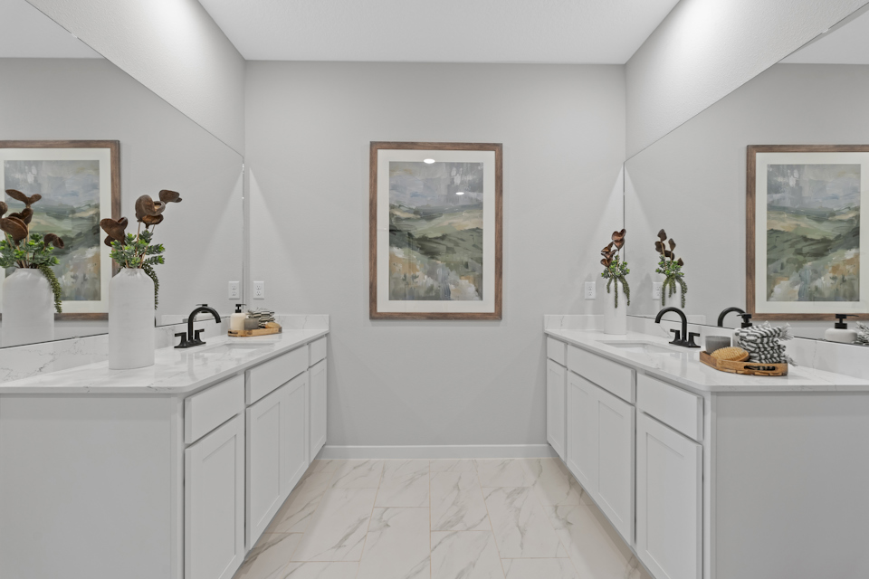 Kenai Model Home Two Primary Bathroom Sink Counters Across From Each Other at Reserve East in Flagler Beach