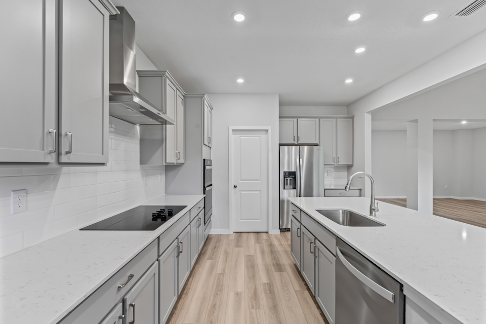 Dogwood Plan Lot 581 Chef's Kitchen with Gray Cabinets at NorthShore in Kingsland