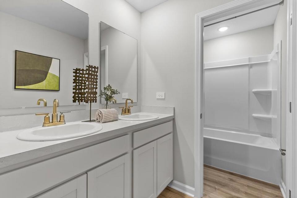 A bathroom with a sink and a shower.
