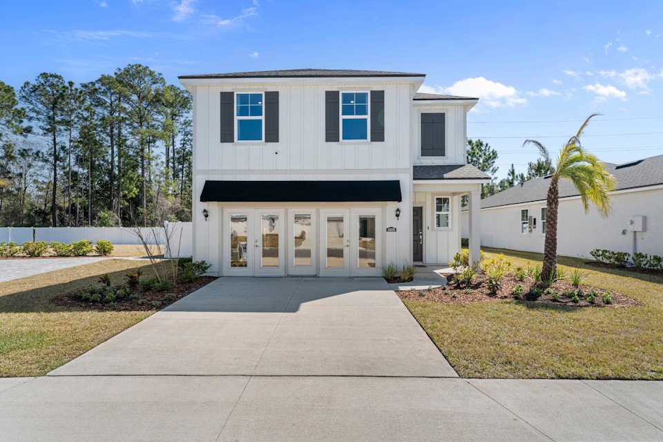 A white house with a driveway.