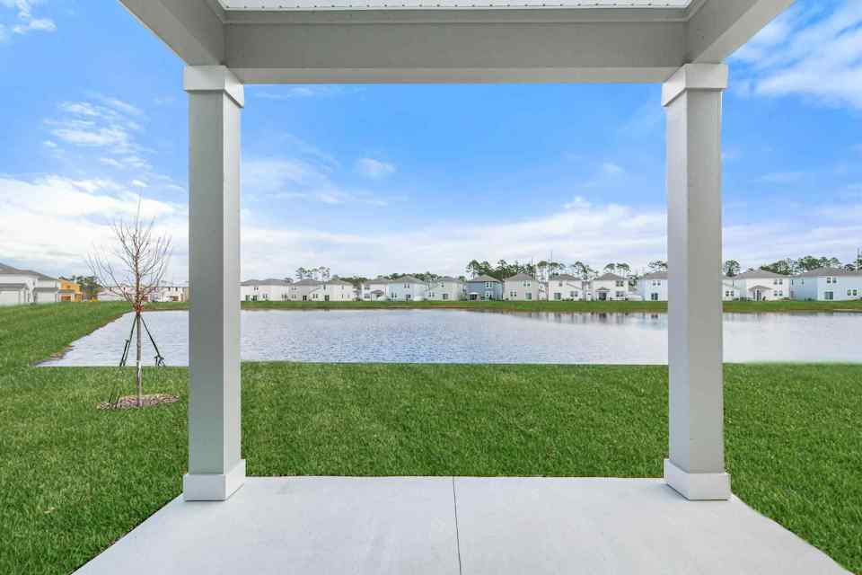 A view of a lake and a town from a balcony.