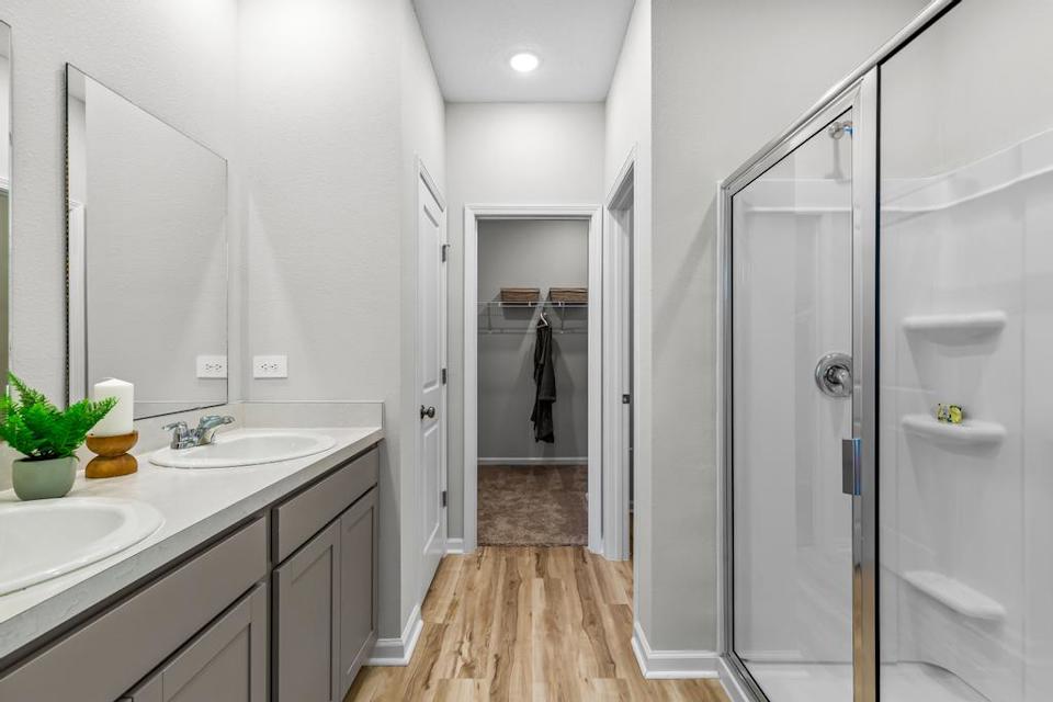 A bathroom with a shower and sink.