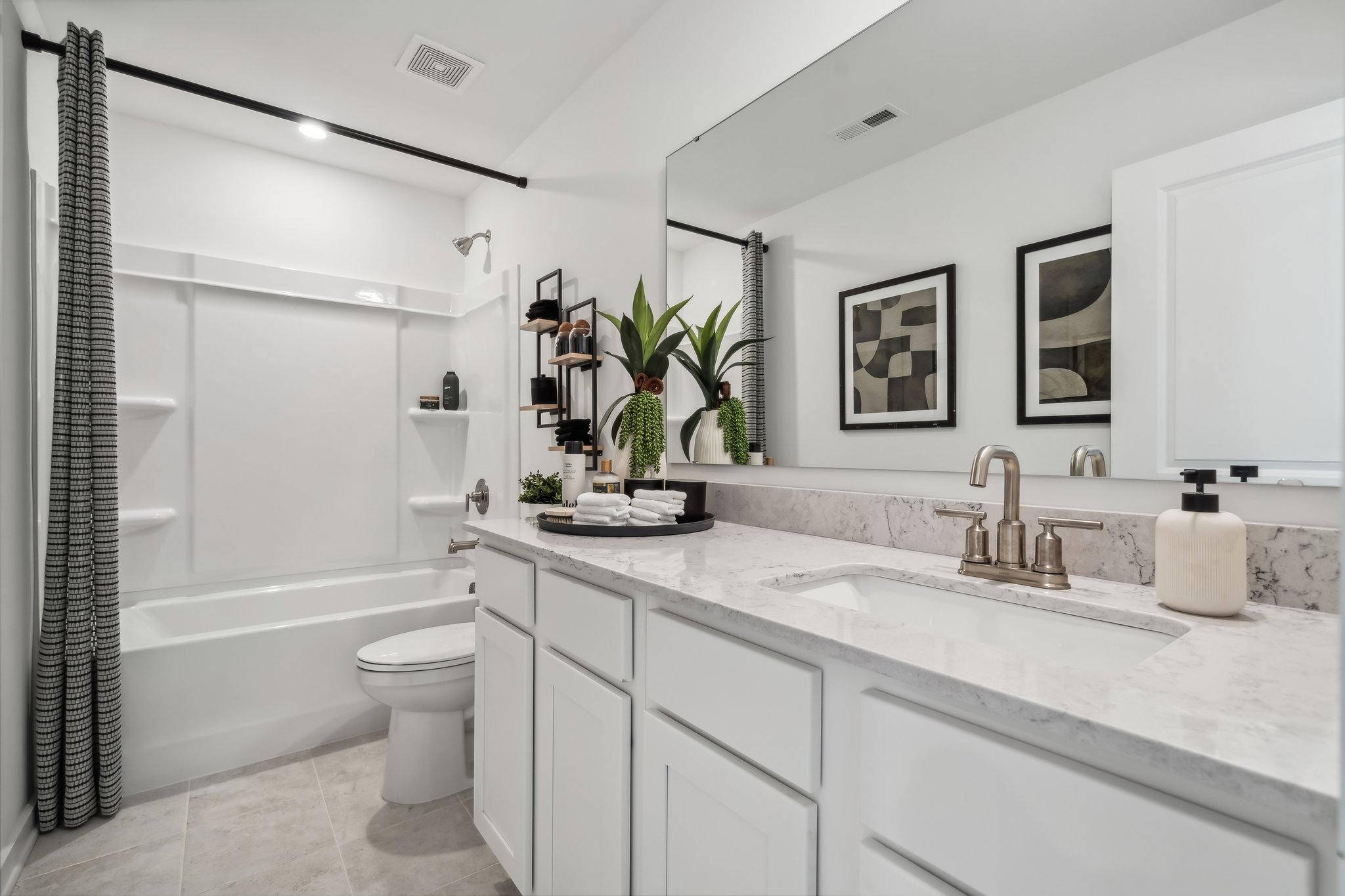 A bathroom with a tub sink and toilet.